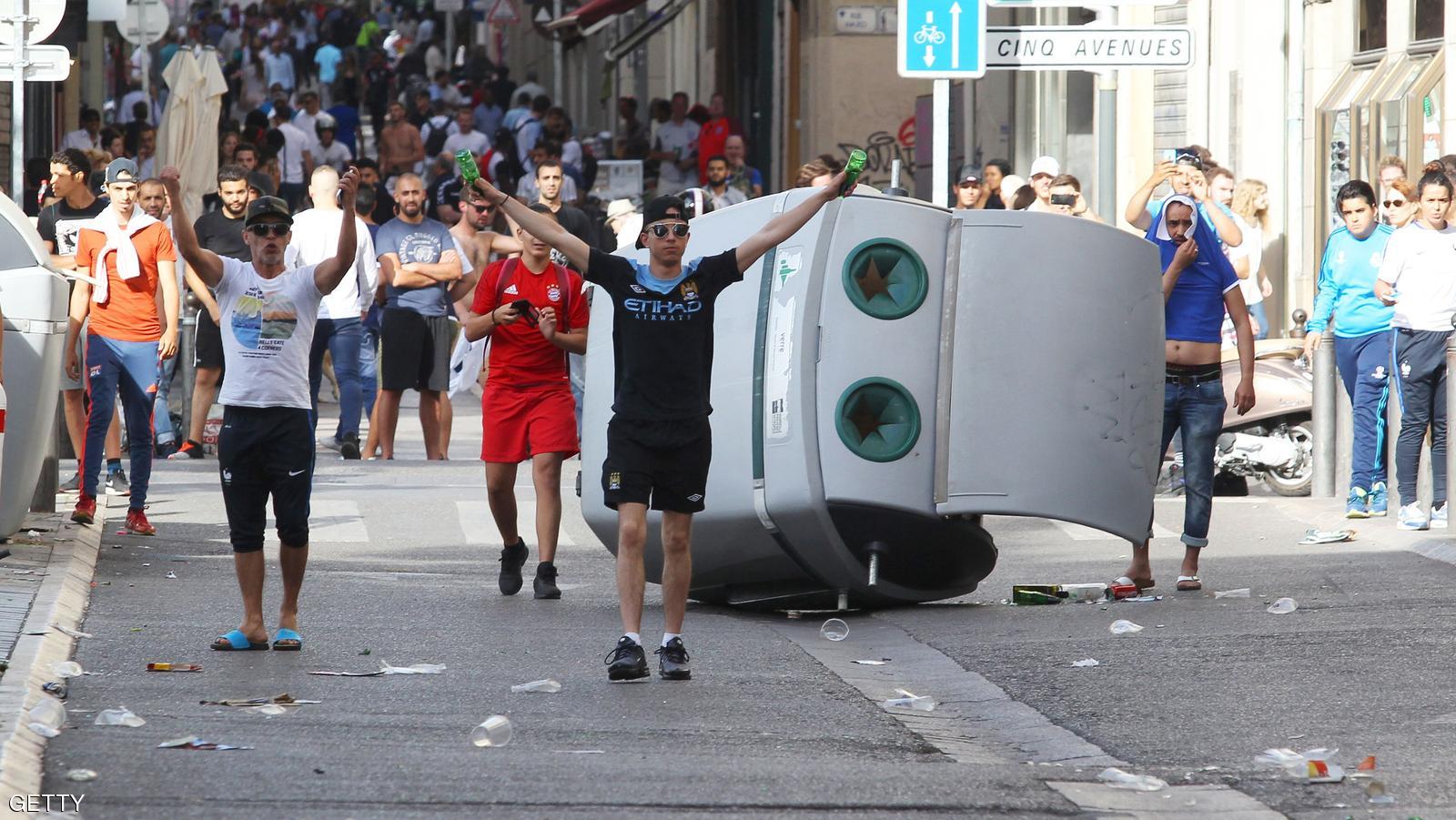 People throw beer cans at English supporters ahead of the Euro 2016 football match England vs Russia, southern France, on June 11, 2016.  Football fans fought pitched battles for the third day in the French city of Marseille ahead of England's European Championship clash with Russia. Bare-chested English and Russian supporters hurled bistro chairs and bottles in the historic Vieux-Port district where the cobbled streets were littered with broken glass and debris.  / AFP / JEAN CHRISTOPHE MAGNENET        (Photo credit should read JEAN CHRISTOPHE MAGNENET/AFP/Getty Images)