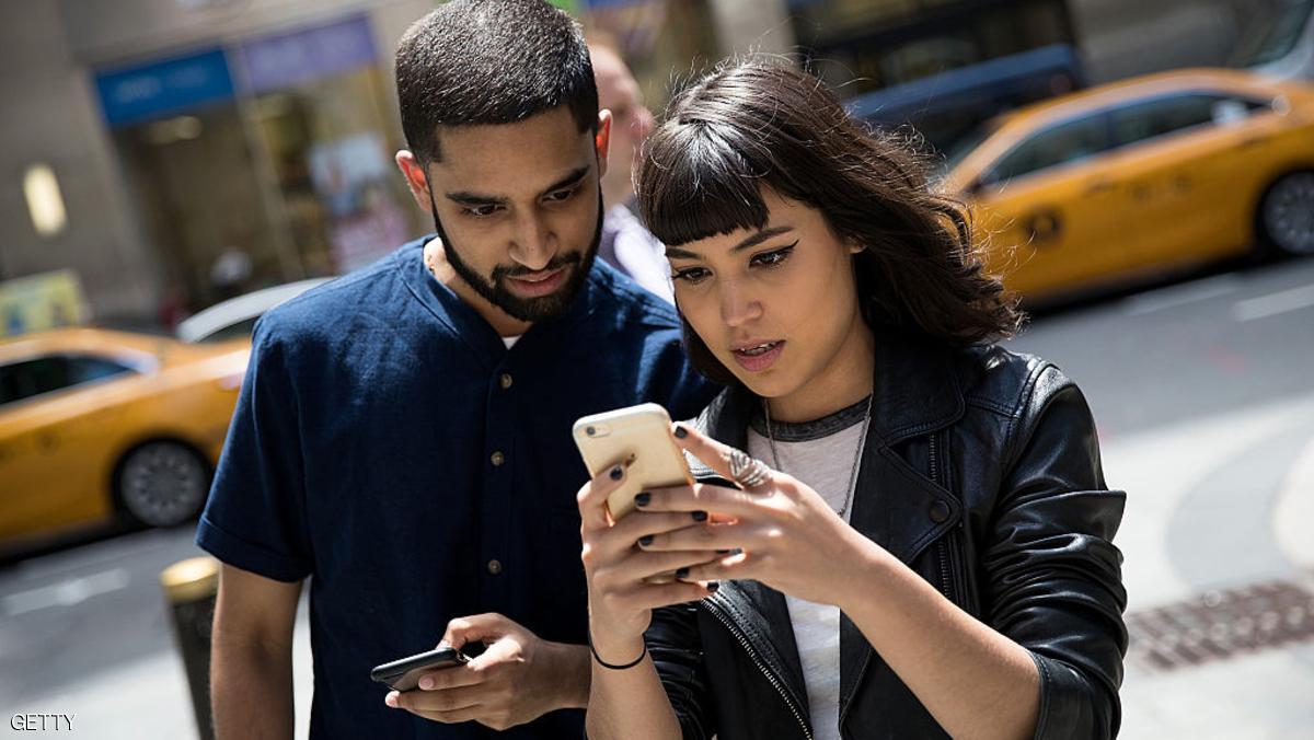 NEW YORK, NY - JULY 11: (L to R) Sameer Uddin and Michelle Macias play Pokemon Go on their smartphones outside of Nintendo's flagship store, July 11, 2016 in New York City.  The success of Nintendo's new smartphone game, Pokemon Go, has sent shares of Nintendo soaring. (Photo by Drew Angerer/Getty Images)