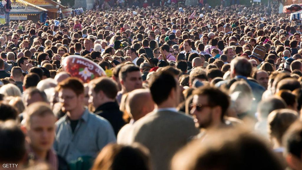 MUNICH, GERMANY - SEPTEMBER 21:  Visitors walk through a crowded street during sunset at the Oktoberfest 2013 beer festival at Theresienwiese on September 21, 2013 in Munich, Germany. The Munich Oktoberfest, which this year will run from September 21 through October 6, is the world's largest beer fest and draws millions of visitors. (Photo by Joerg Koch/Getty Images)